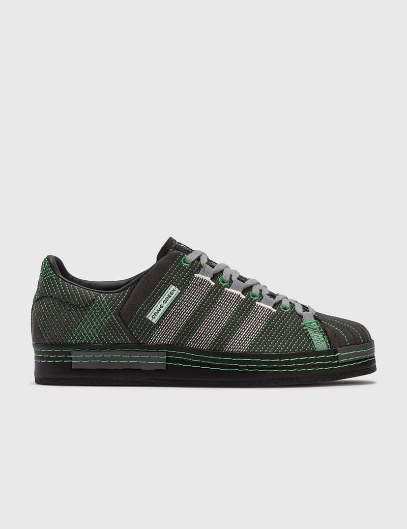 green and black adidas trainers