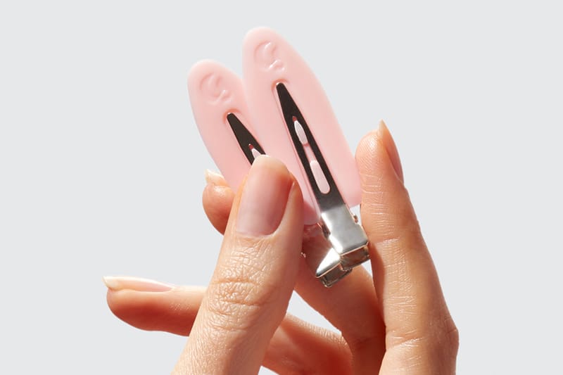 Glossier Is Giving Away These Pink Logo Hair Clips for Free