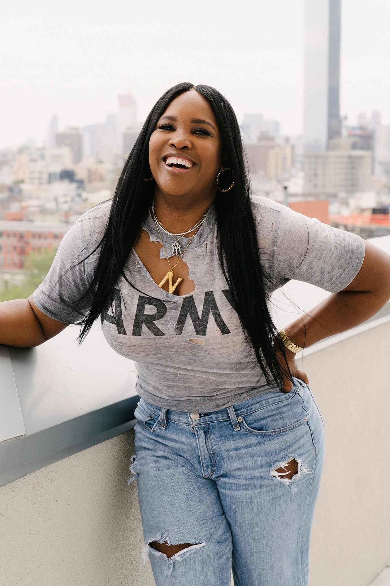 Nikki Nelms Celebrity Hairstylist New York Sister City Hotel Skyline Celine Phoebe Philo Alphabet Necklace Distressed Army Grey T-shirt Black Long Hair Jeans