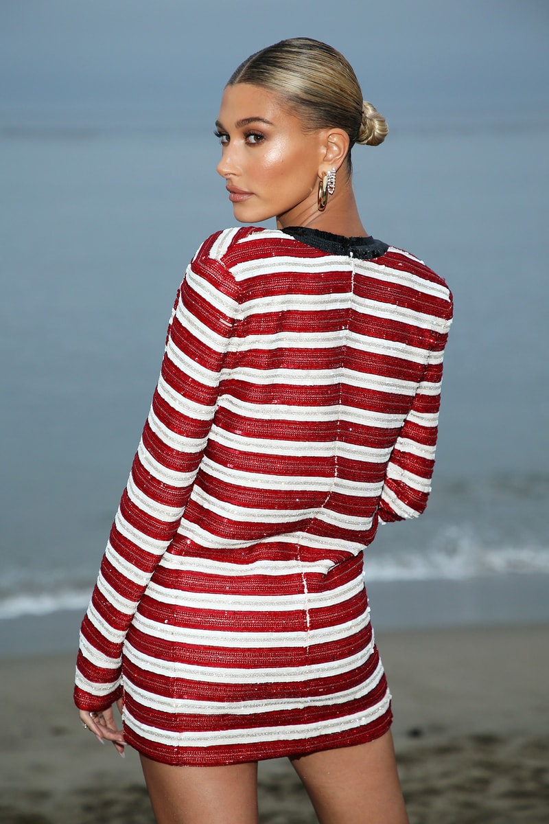 Hailey Bieber Baldwin Saint Laurent Men's Runway Show SS20 Spring Summer 2020 Malibu California Beach Ocean Outfit Red White Stripes Striped Dress Low Bun Hairstyle Makeup