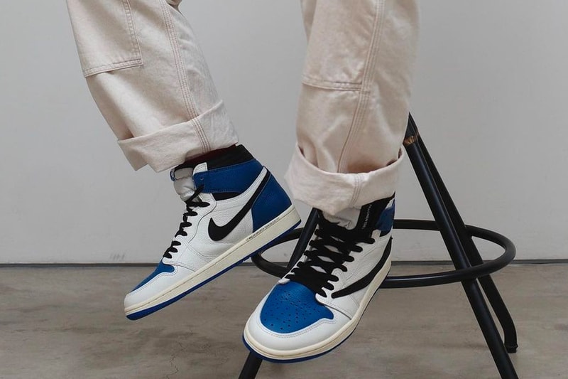 travis scott fragment design air jordan 1 aj1 high og military blue closer look stool sitting on foot