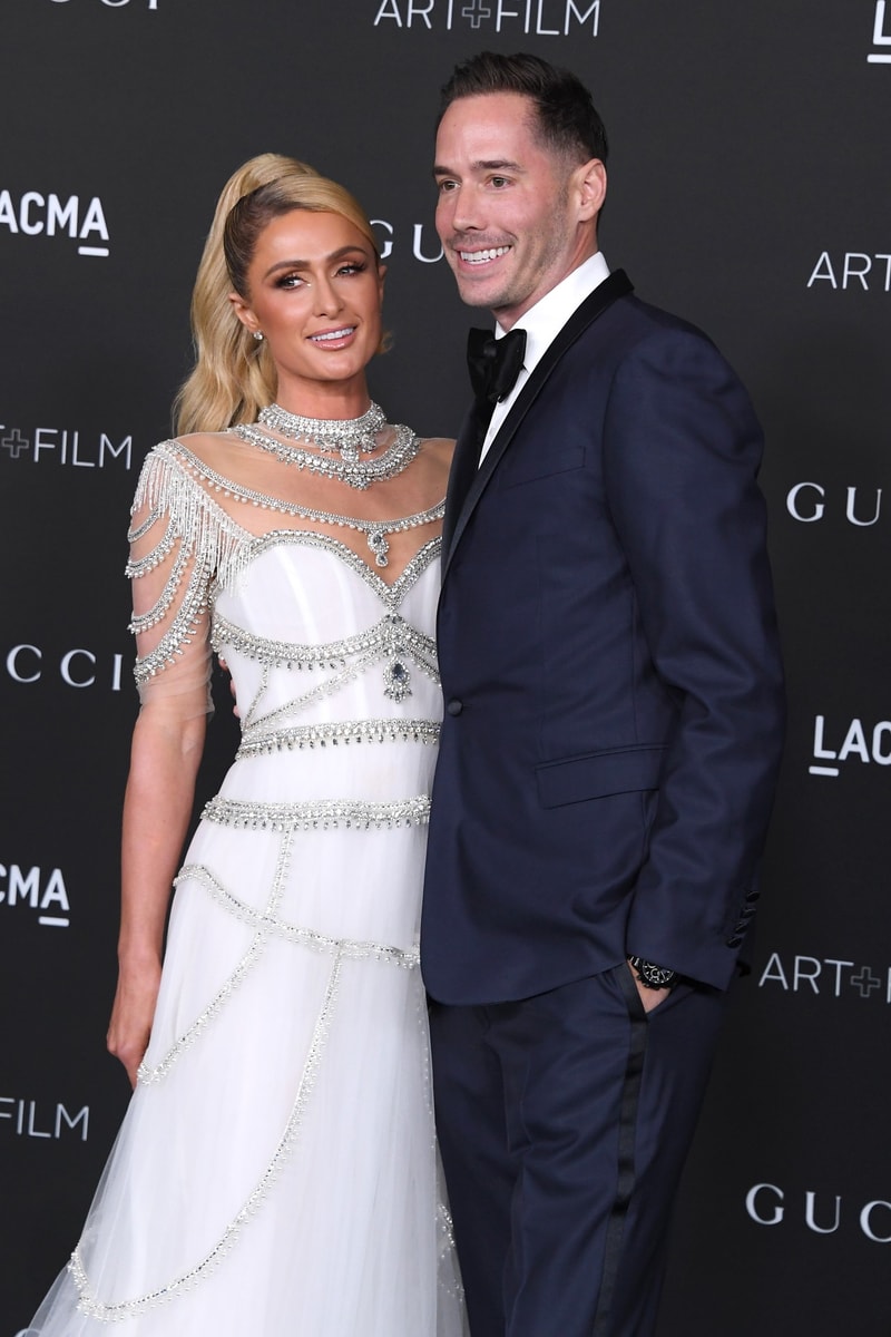 paris hilton fiance husband carter reum posing white dress blue tux