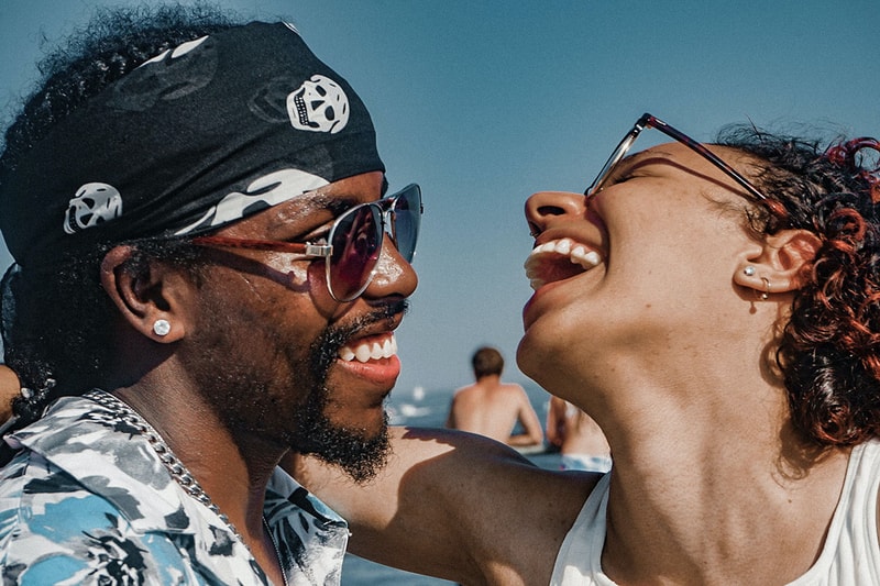 Happy couple smiles on date at beach