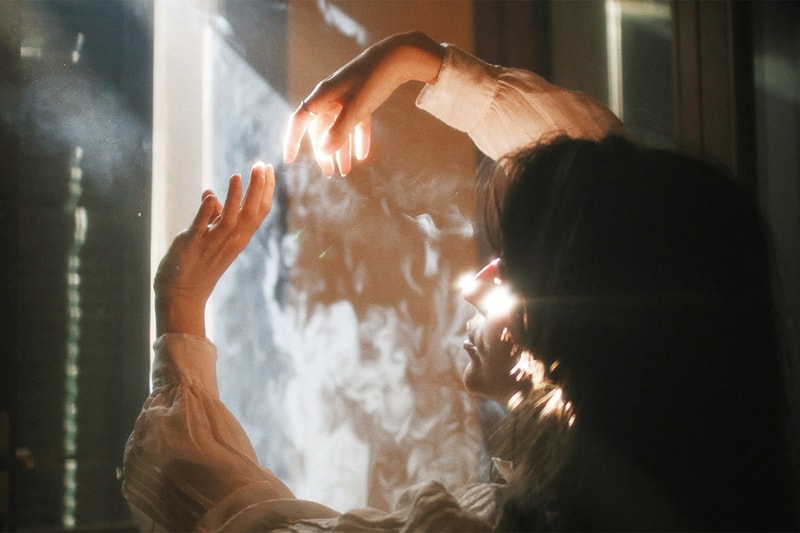 Woman Wafting Smoke in Room