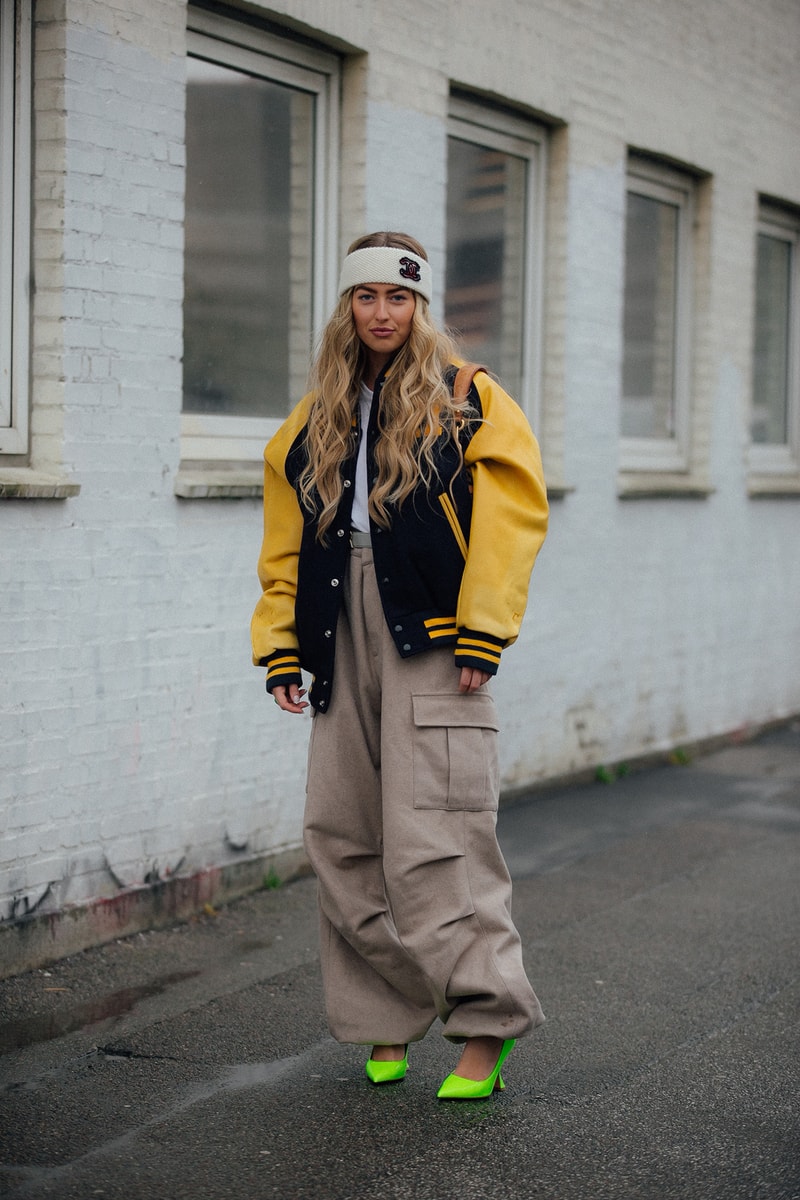 Emili Sindlev Copenhagen Fashion Week FW22 Fall Winter 2022 Street Style Influencer Danish Varsity Jacket Yellow Chanel Headband Amina Muaddi Neon Green Heels
