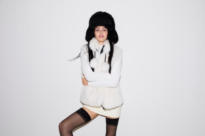 amelia gray girl laying on bed jacket fur pink legs shoes