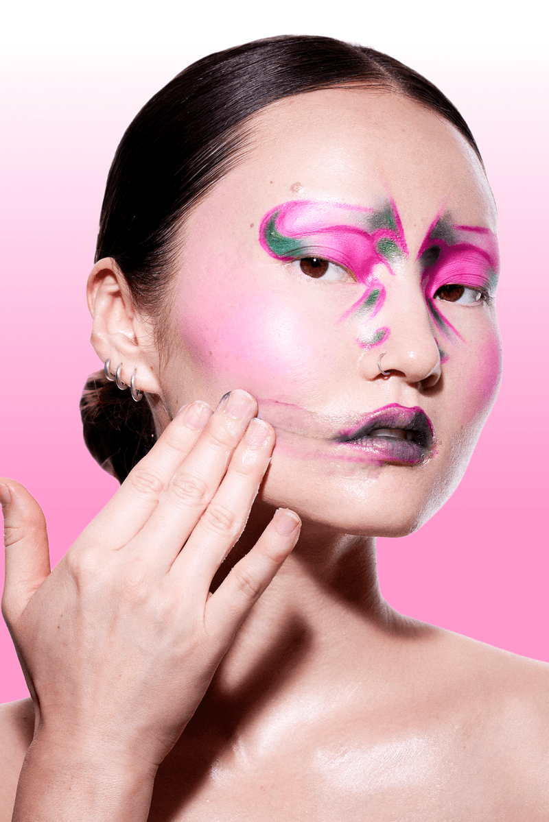 futurewise, korean skincare, slugging, woman with bright makeup wiping her band on face, cleanser