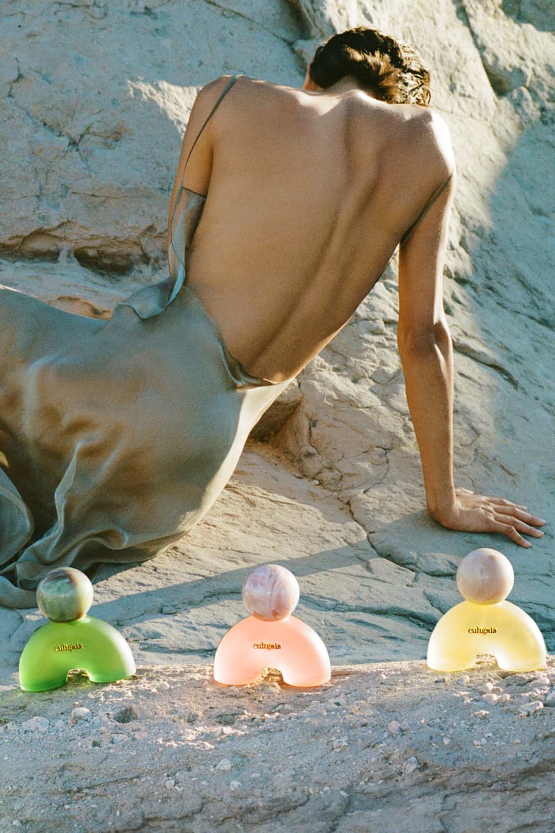 woman lying down in desert in sage colored dress, cult gaia, fragrance launch