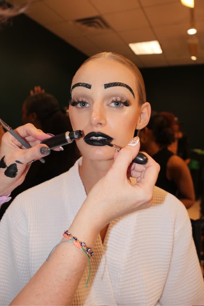 woman with sculpted, gel hair getting her makeup done, luar, ss25, fashion week, tresemme, mac cosmetics