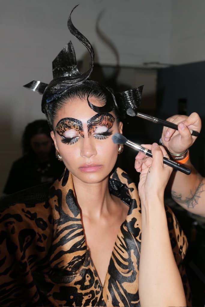 woman with sculpted, gel hair getting her makeup done, luar, ss25, fashion week, tresemme, mac cosmetics
