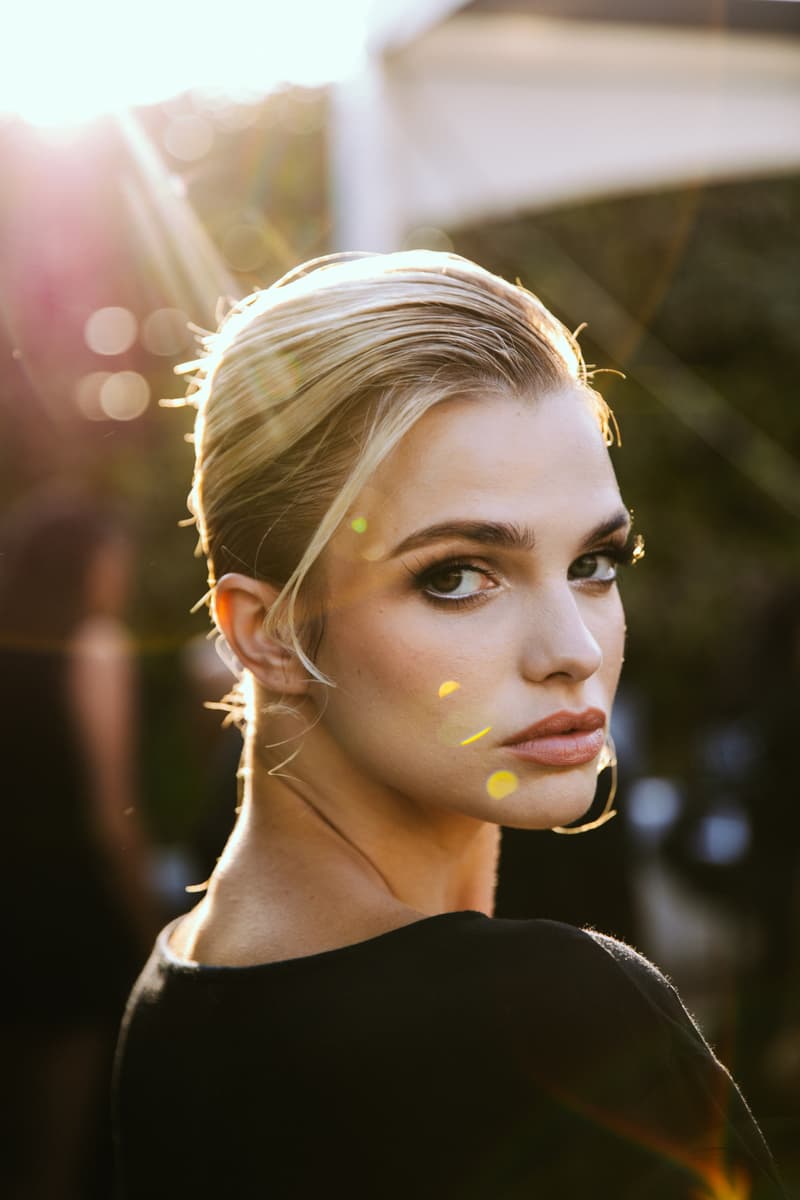 woman getting her curly hair done by two people, laquan smith, mac cosmetics, camille rose, hair, makeup, fashion week