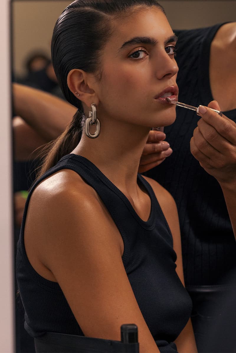 model getting lip gloss painted on, rabanne beauty, paris fashion week, spring/summer 2025