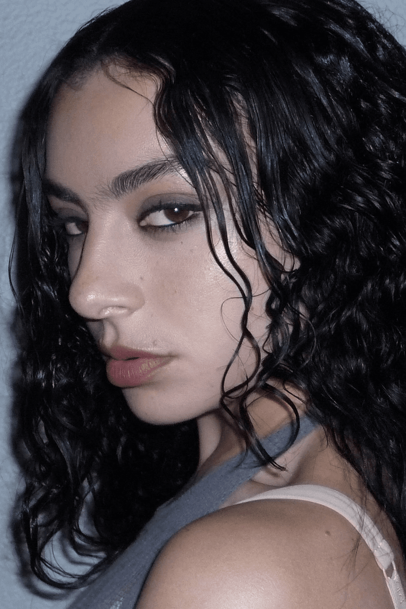 charli xcx with a smokey eyeshadow posing, valentino beauty partnership, makeup, brat summer 