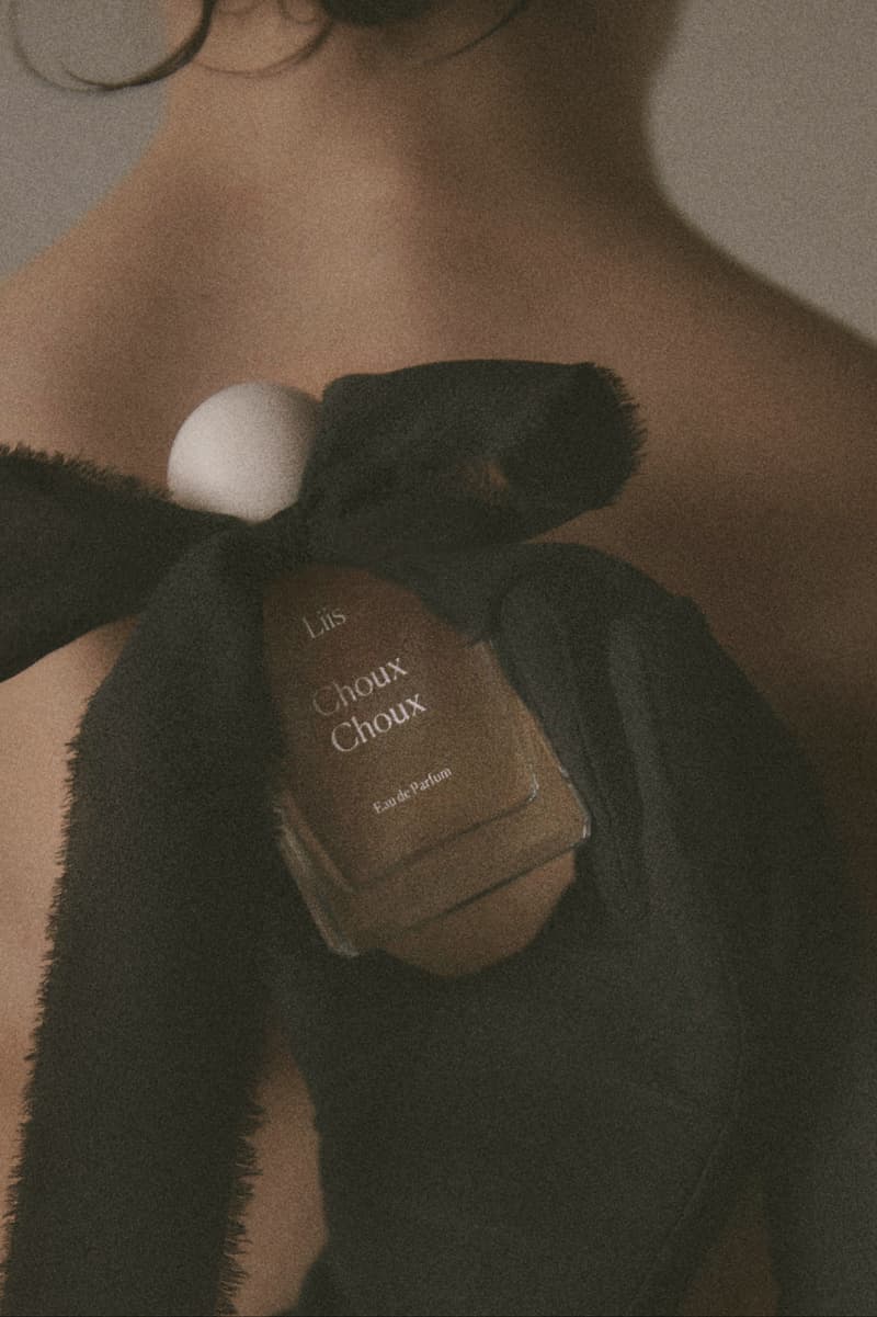 fragrance laid out on table with pastries, bow, fragrance 