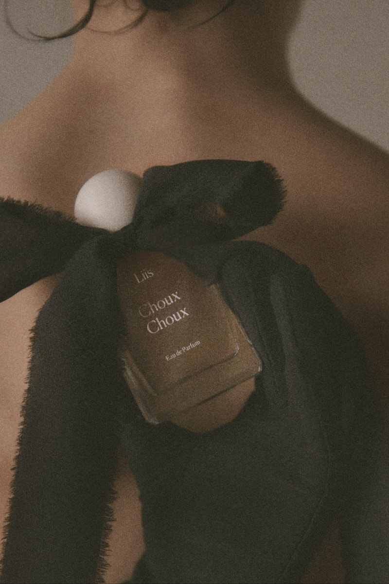 fragrance laid out on table with pastries, bow, fragrance 