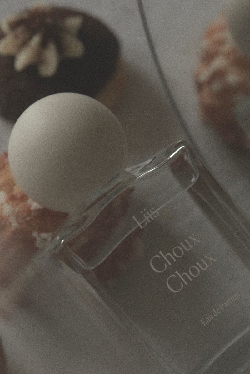 fragrance laid out on table with pastries, bow, fragrance 