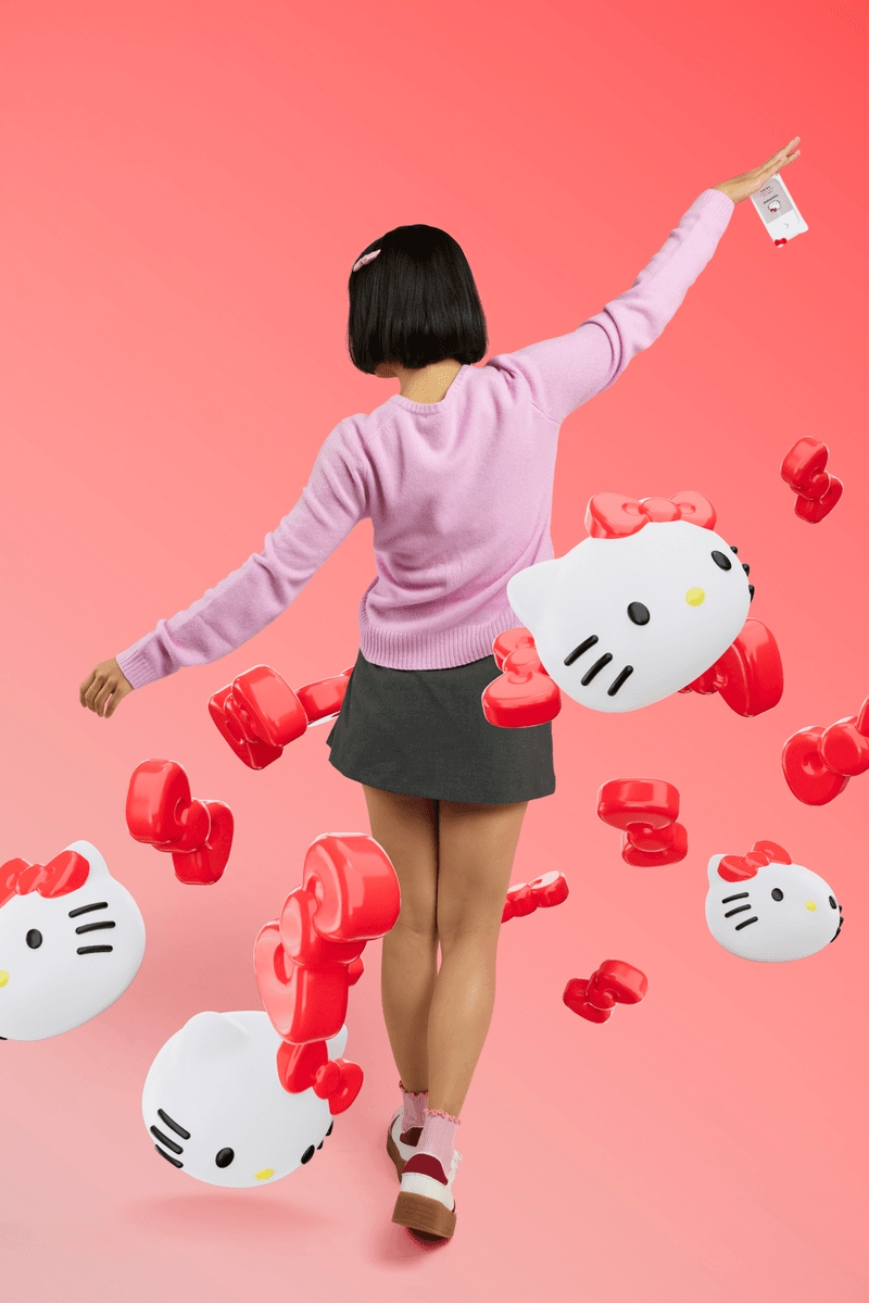 woman with bob surrounded by hello kitty sanrio touchland hand sanitizers, beauty, 50th anniversary