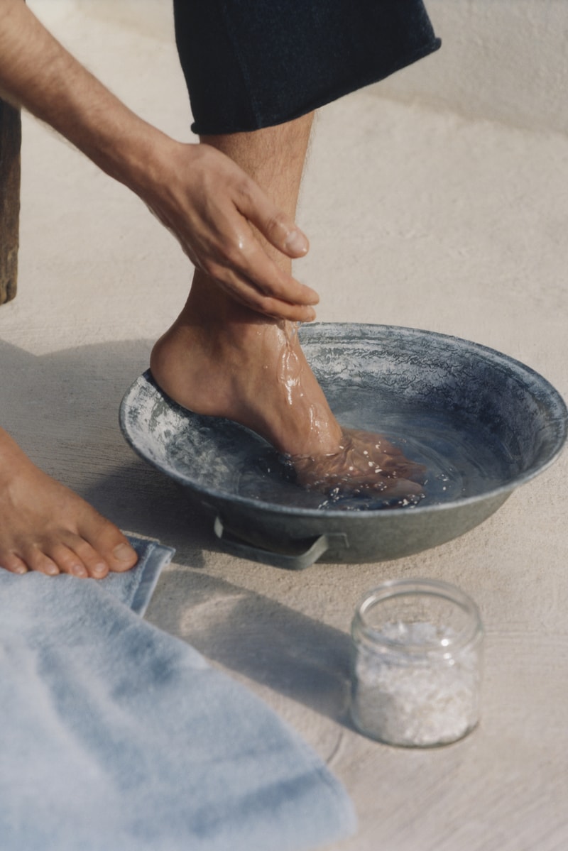 two people laying in the water on the beach in swimsuits, birkenstocks, footwear, foot care, wellness