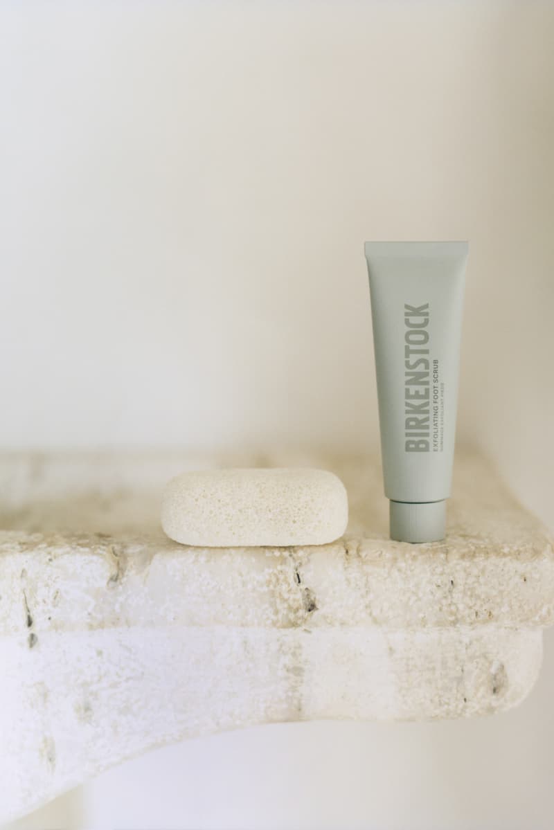 two people laying in the water on the beach in swimsuits, birkenstocks, footwear, foot care, wellness
