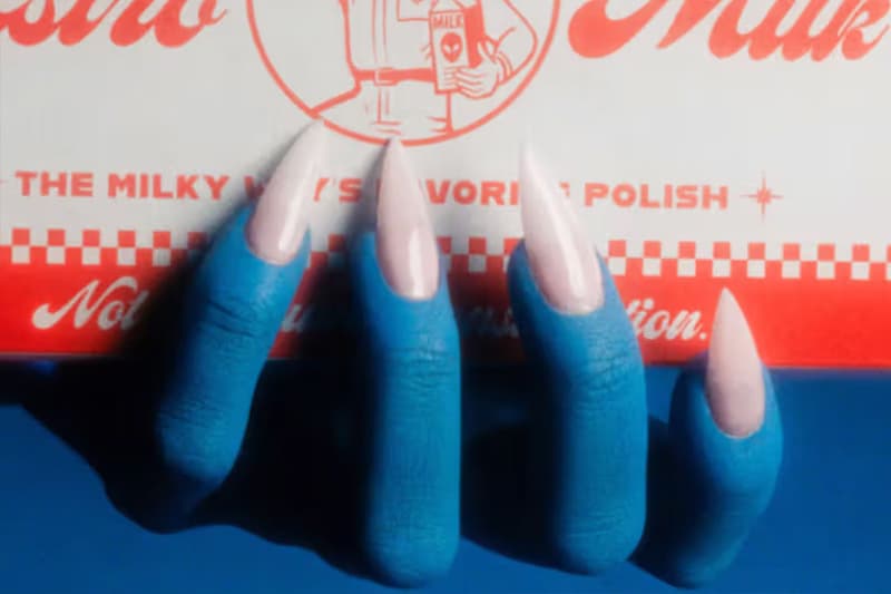 blue hands with pink nail extensions gripping a red bar of soap, halloween nail inspiration