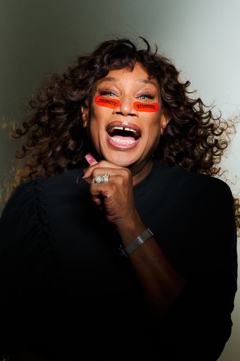 woman with curly hair and dieux "promote homosexuality" forever eye mask, skincare