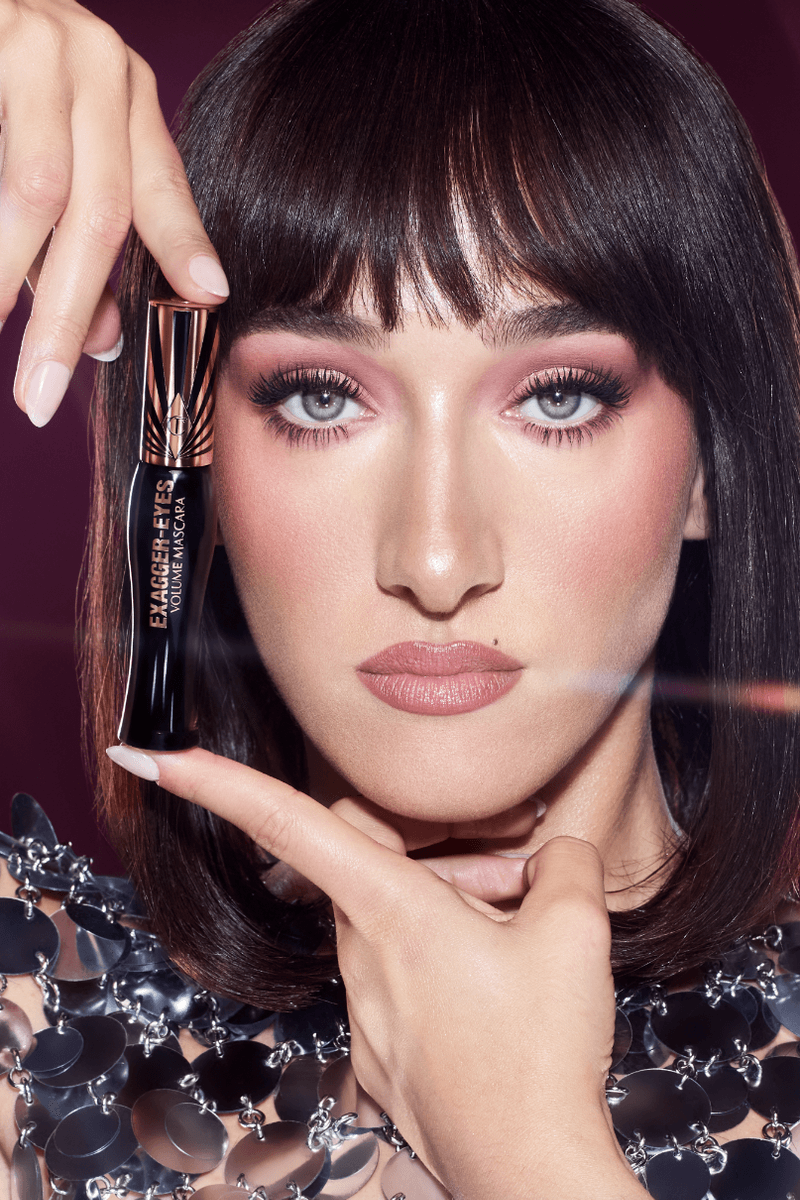 michaela jay posing with highlighter wand, charlotte tilbury holiday campaign, beauty, makeup 