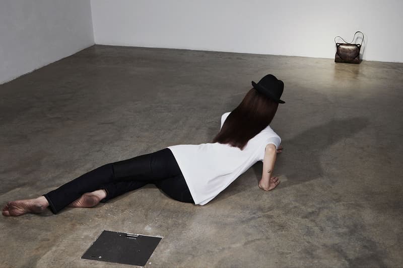 puppets and puppets brand bags woman floor legs leather black hair sunglasses