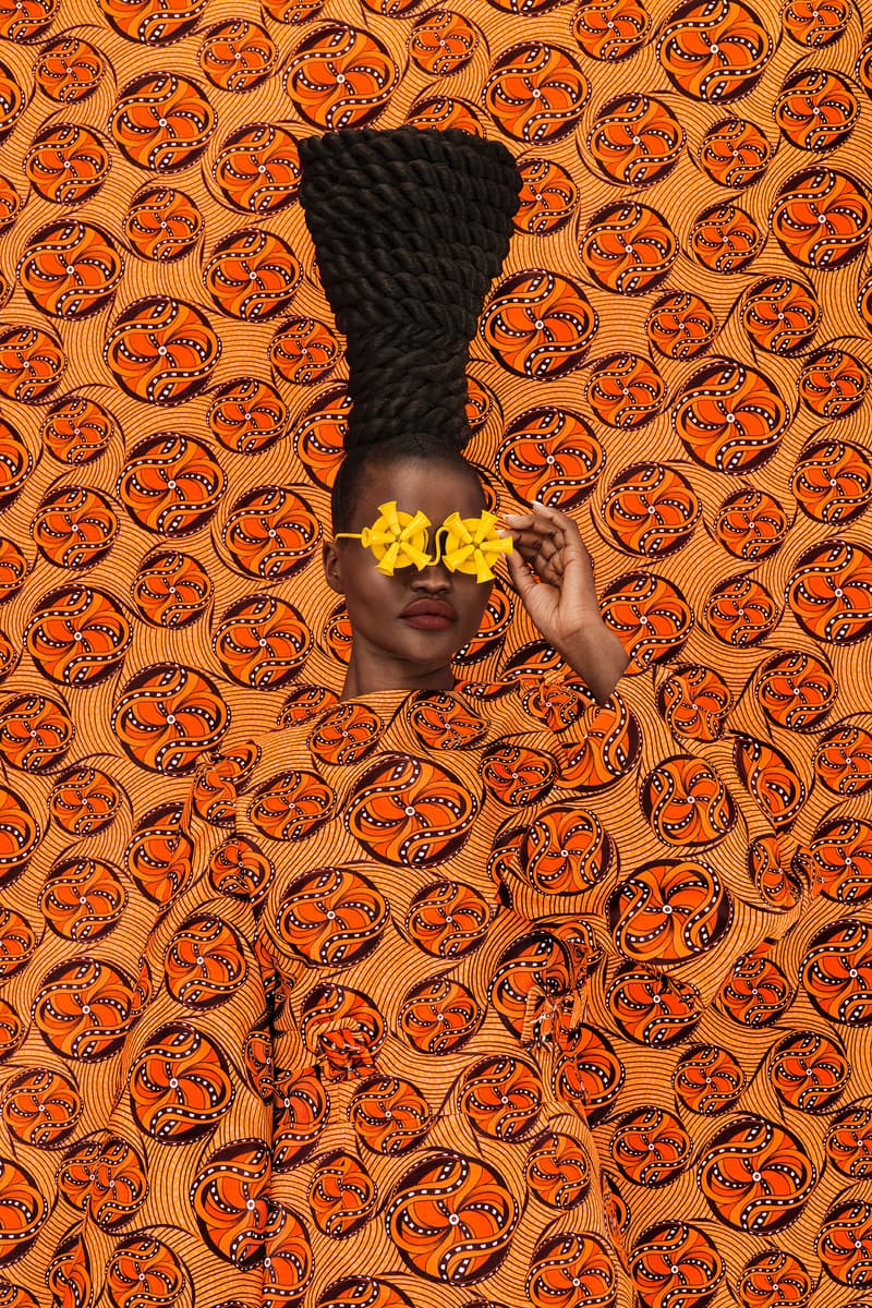 woman with sculptural braids and dreads posing with blue sunglasses, oribe haircare, holiday 2024, hair