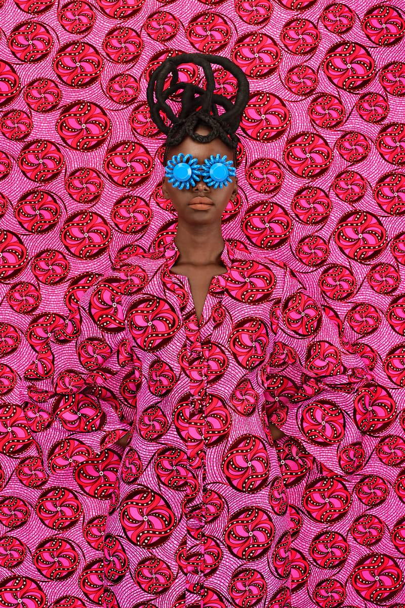 woman with sculptural braids and dreads posing with blue sunglasses, oribe haircare, holiday 2024, hair