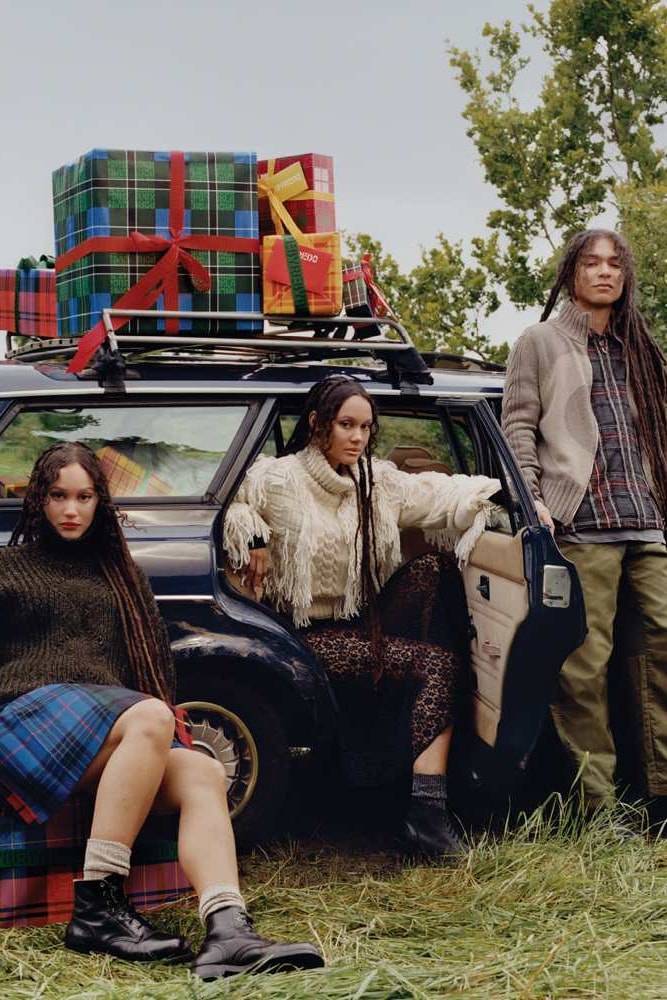 two twins posing together in grassy forest sharing a coat, byredo holiday, fragrance, makeup, perfume 