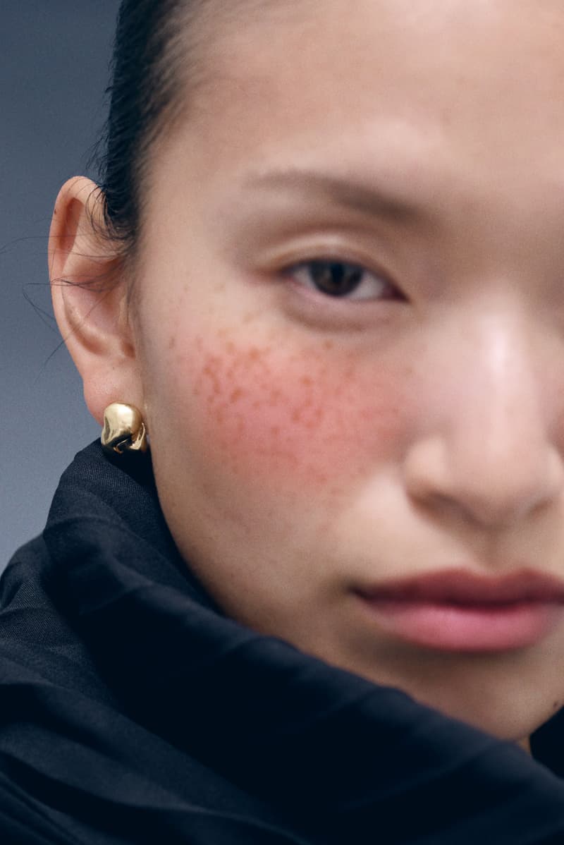 woman wearing merit and completedworks earrings close-up, accessories, fragrance, makeup, skincare