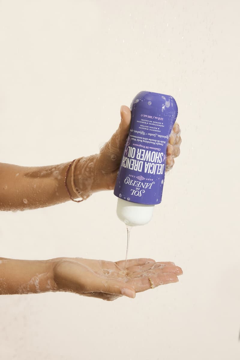 model applying shower oil during self care routine, sol de janeiro, brazilian beauty, skincare, body care