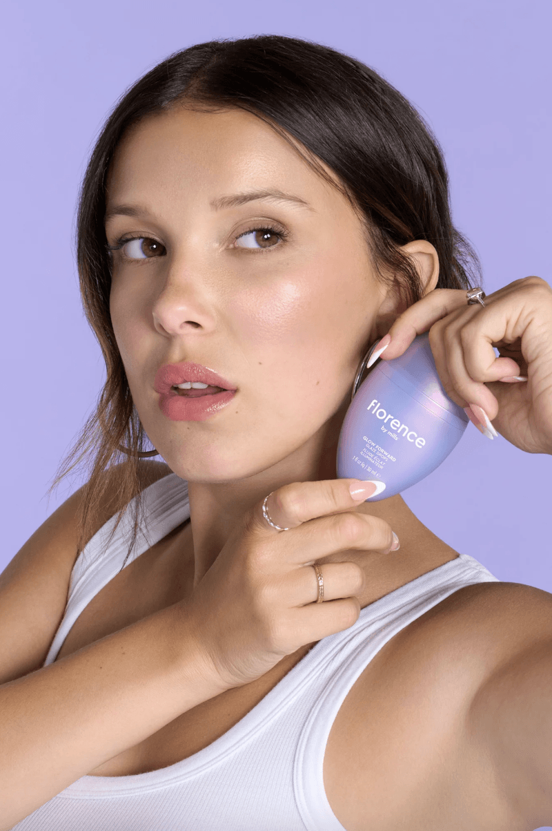 millie bobbie brown posing with new glow drops, skincare, florence by mills, cha cha matcha latte, beauty 