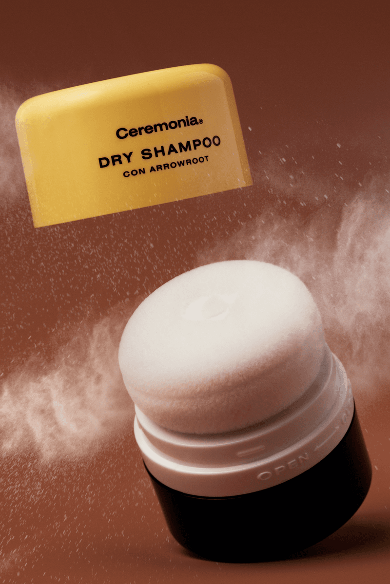 model applying dry shampoo in a powder puff, babba rivera, latinx haircare, hair, beauty