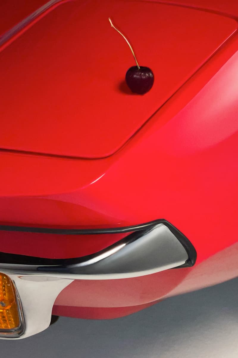 woman posing on top of a convertible with glossier balm dot com in her hand, black cherry collection, makeup, skincare