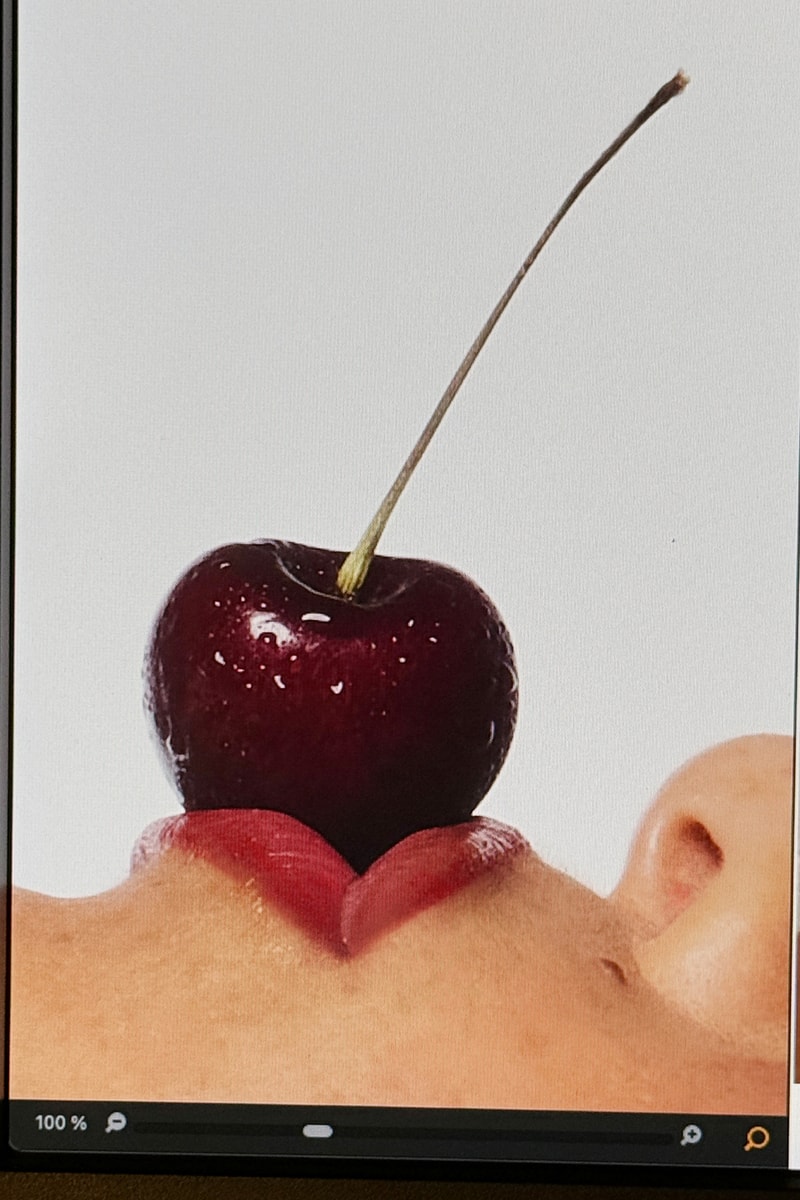woman posing on top of a convertible with glossier balm dot com in her hand, black cherry collection, makeup, skincare
