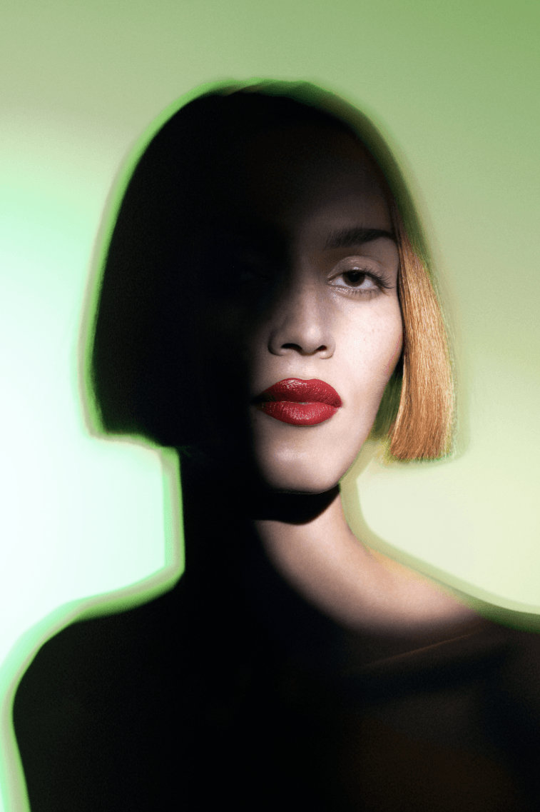 woman surrounded by flowers laying down, od beauty, makeup brand, ossiel ramos, diego díez