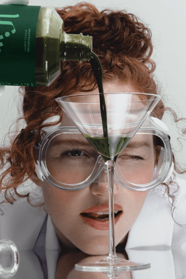 woman pouring matcha beverage into martini glass, non-alcoholic drinks, zero proof, kin euphorics, ghia, de soi, beauty, wellness