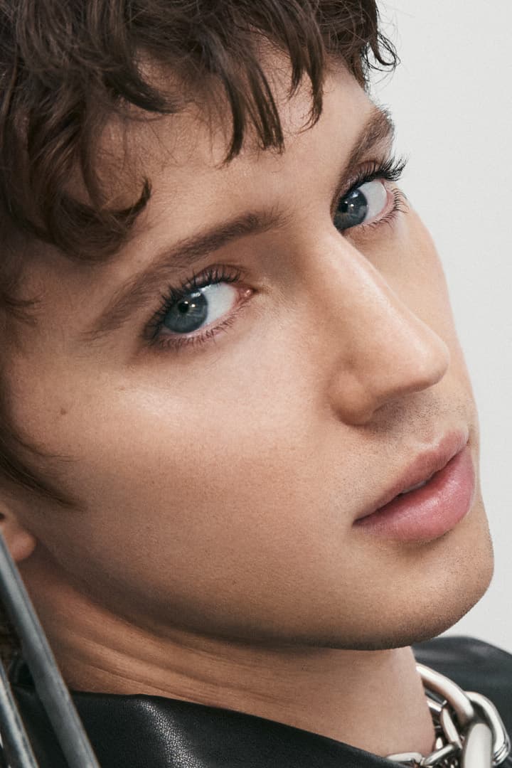 troye sivan posing in a chair, rabanne beauty mascara, makeup