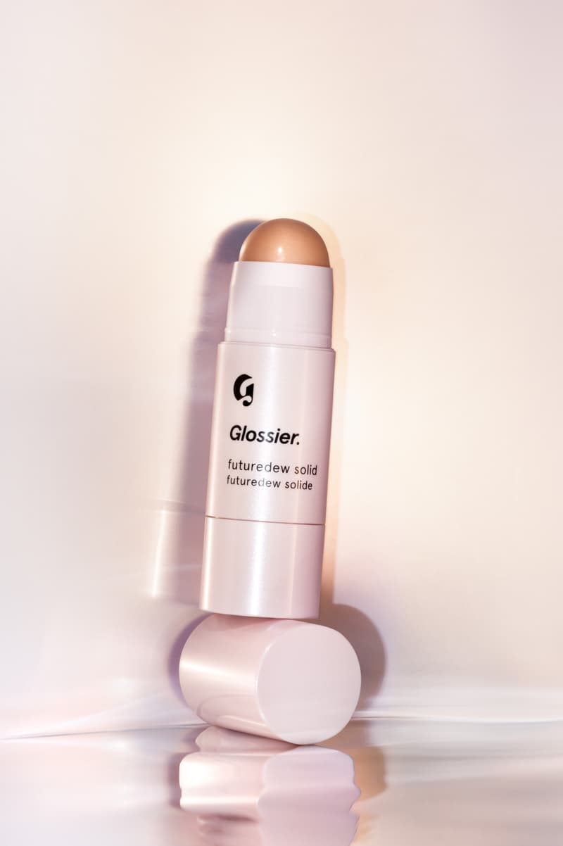 woman posing with new glossier futuredew solid serum, skincare-makeup hybrid, beauty