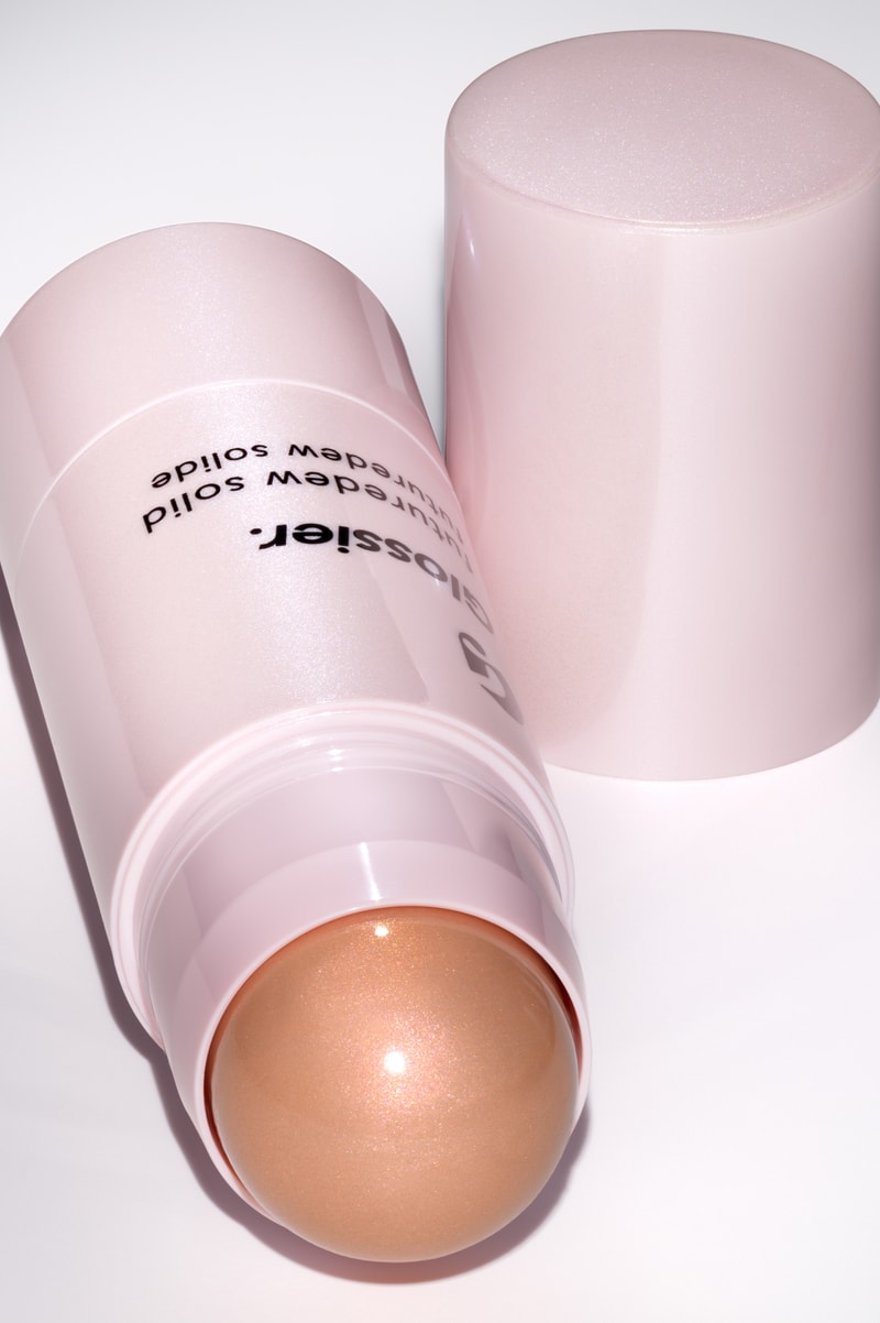 woman posing with new glossier futuredew solid serum, skincare-makeup hybrid, beauty