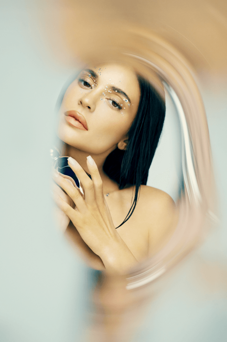 kylie jenner holding a bottle of fragrance, cosmic 2.0 perfume, beauty, kylie cosmetics