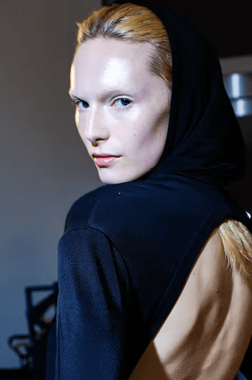 alex consani wearing a hood with glowing skin, skin cocooning, skincare, beauty