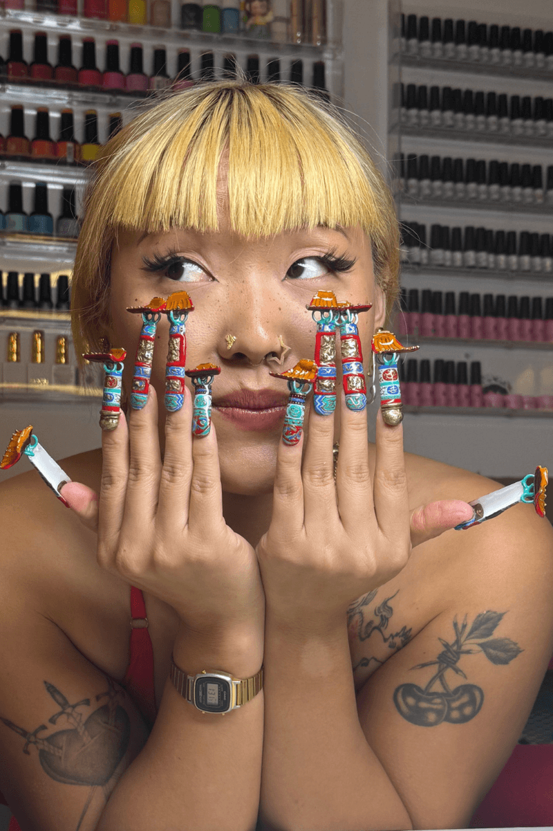 woman showing off nail art, the smithsonian institution nail tech collaboration, museum manicure, beauty