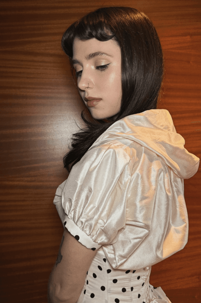 clairo posing with ilia makeup on, first-ever beauty ambassador, skincare