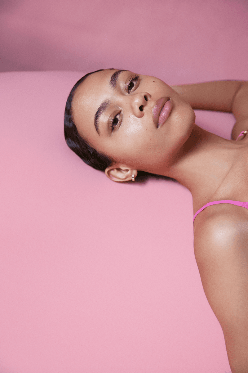 woman posing with new kosas double cleansing system, woman washing her makeup off, new cleanser, skincare, beauty