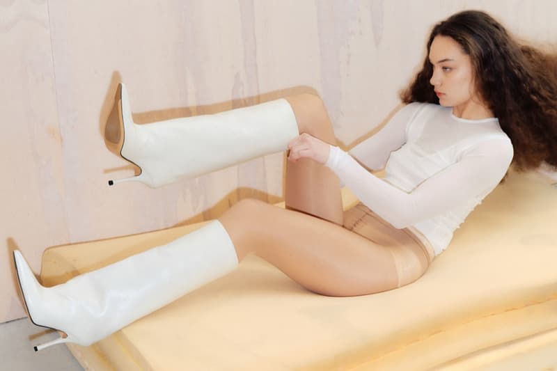 marko bakovic woman heels tights body laying down sofa mules boots