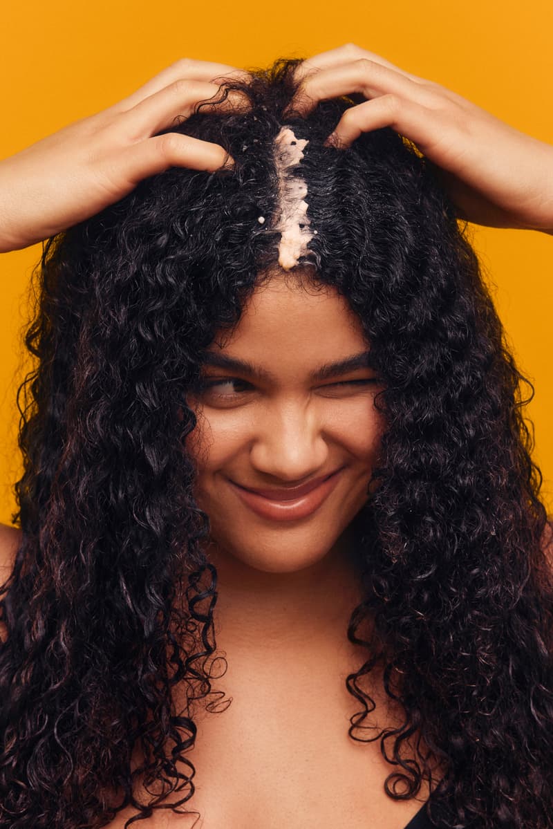 woman putting scalp scrub on her head, haircare, best hair growth beauty products, pattern beauty, oribe, augustinus bader, nutrafol, oneskin, act+acre, the ordinary, the nue co.