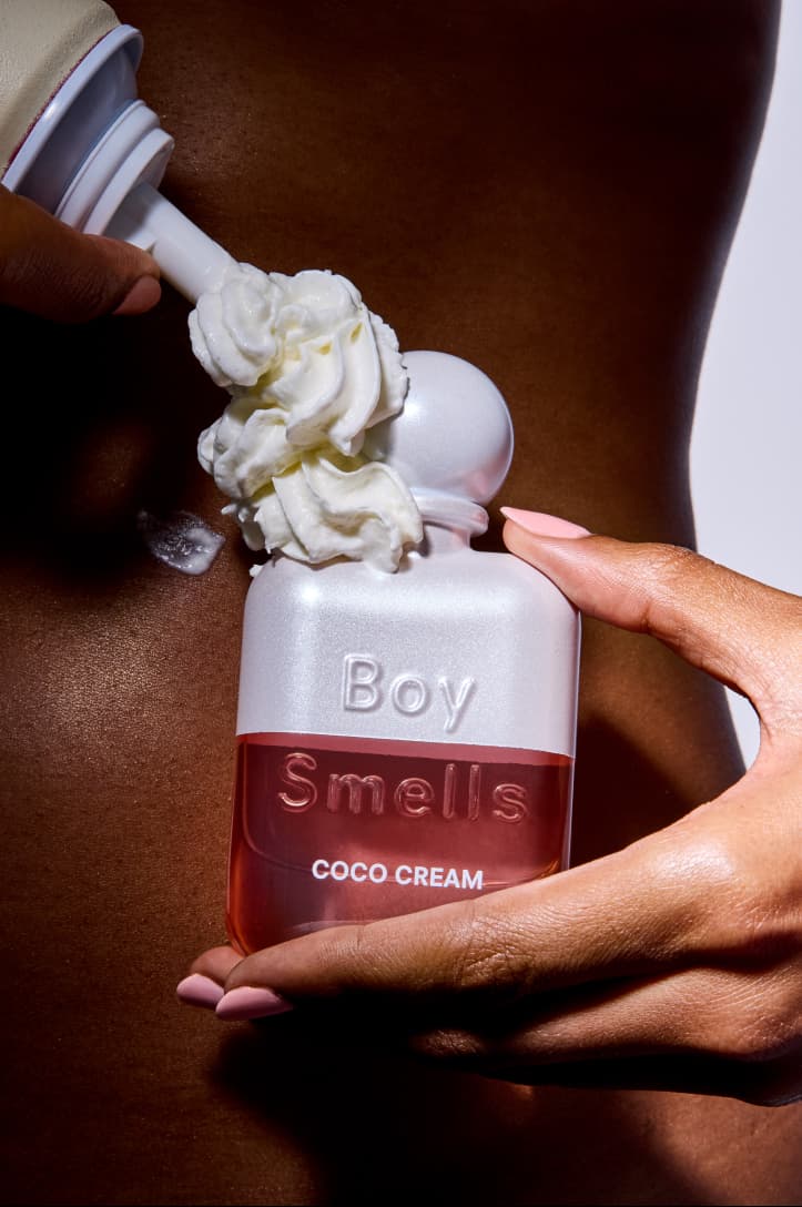 woman holding boy smells fragrance in white skirt, new rebrand, candles, beauty