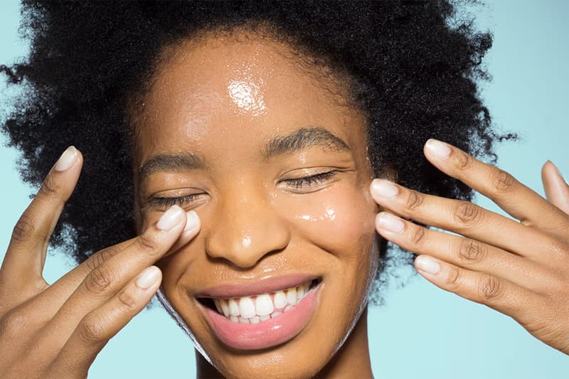 woman putting a serum on her face, peptide explainer, skincare, beauty